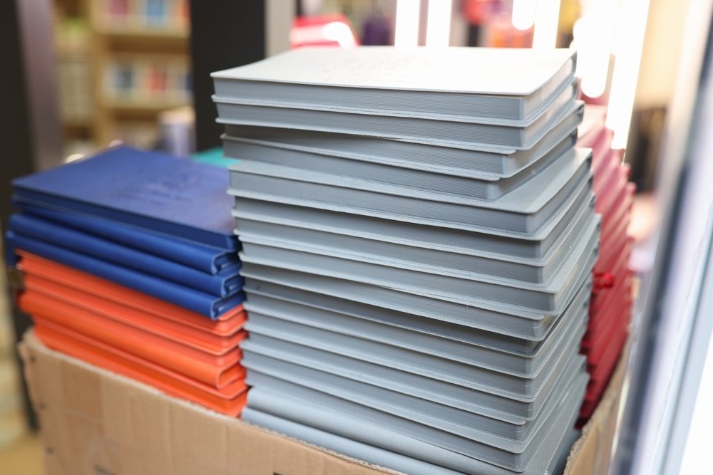 New,Paper,Notebooks,Stacks,On,Cardboard,Box,In,Stationery,Store.